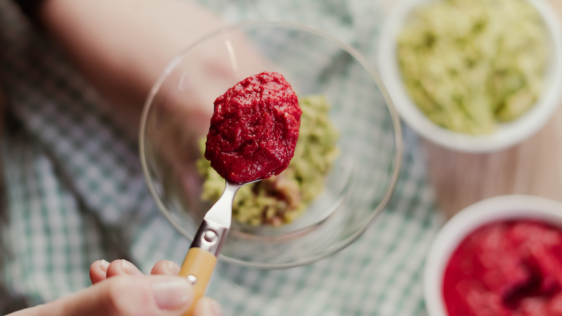 Beet and tomato mixture over the guacamole